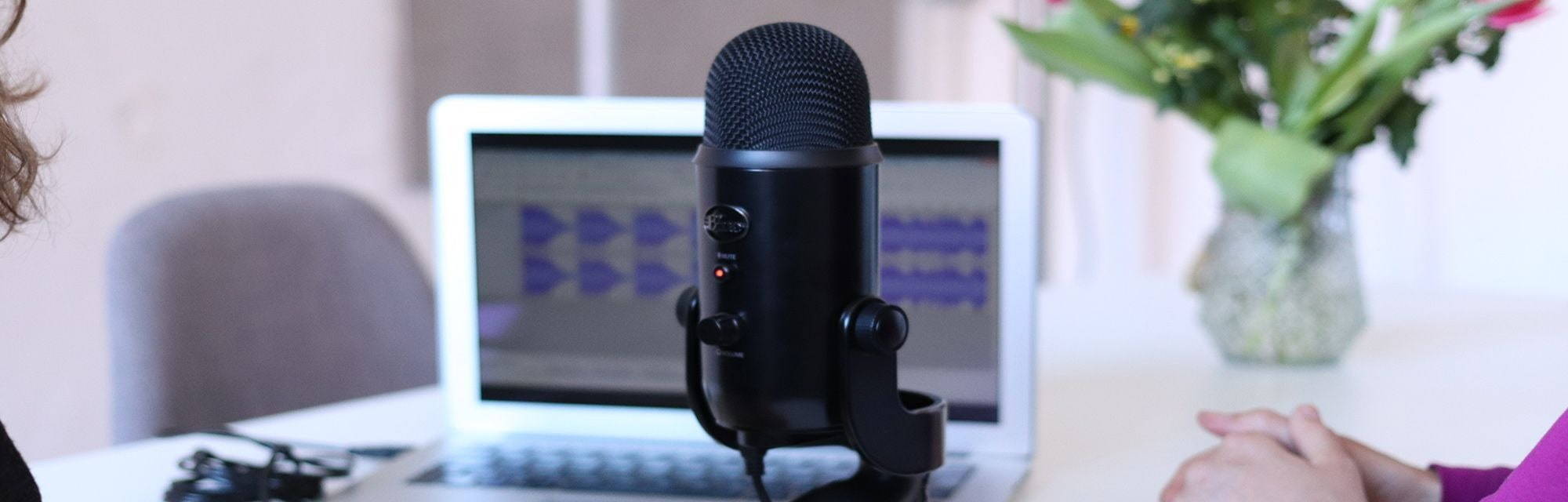 Microphone on desk in front of a laptop