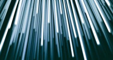 Bright white light streaks extend downward against a dark background, creating a dynamic and abstract visual effect.