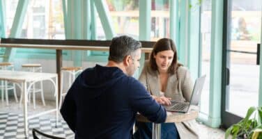 Two people discussing how to improve a candidates job profile