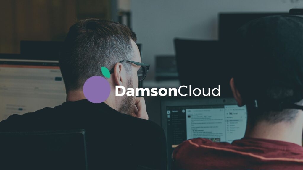 Two people working at computers with the DamsonCloud logo overlayed.