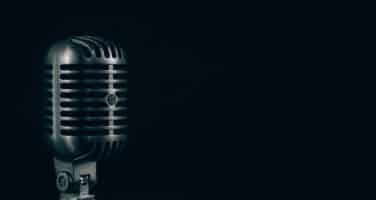 A vintage-style microphone is positioned on the left against a dark background, highlighting its classic metal grille and retro design.